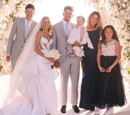 Patrick Mahomes with his wife, daughter, mother, brother and sister on his wedding day